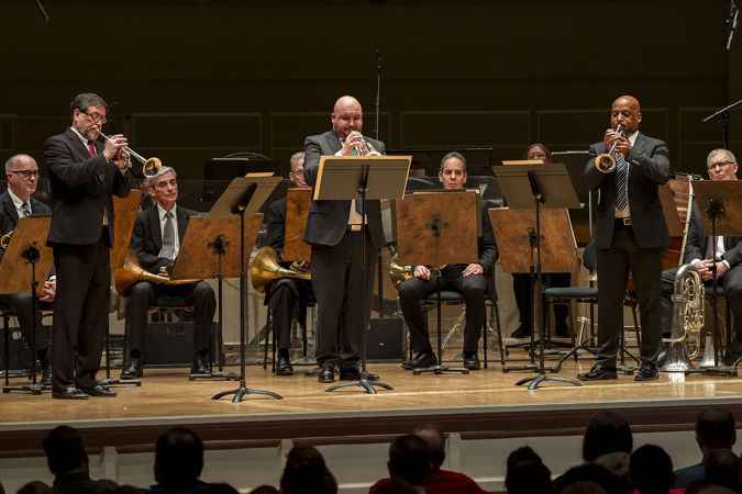 a trumpet trio performs