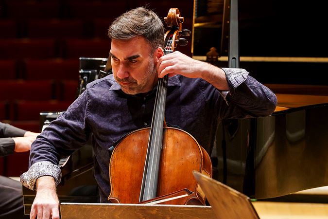 Closeup of CSO cello Kenneth Olsen performing on stage