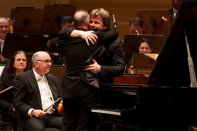Simon Trpčeski and Jakub Hrůša embrace after their performance of Rachmaninov's First Piano Concerto with the CSO