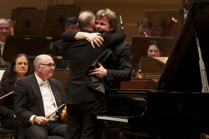 Simon Trpčeski and Jakub Hrůša embrace after their performance of Rachmaninov's First Piano Concerto with the CSO