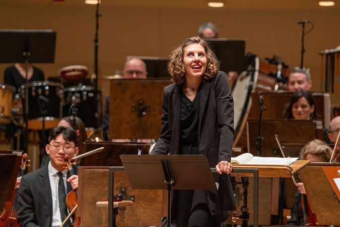 conductor speaking from stage