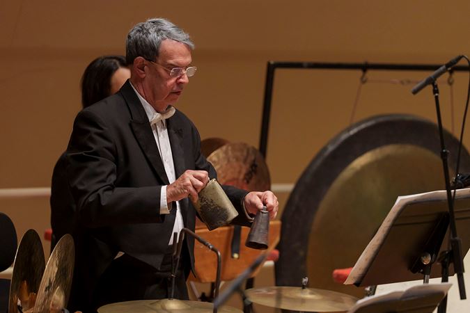 Closeup of former CSO percussion Jim Ross playing the cowbells