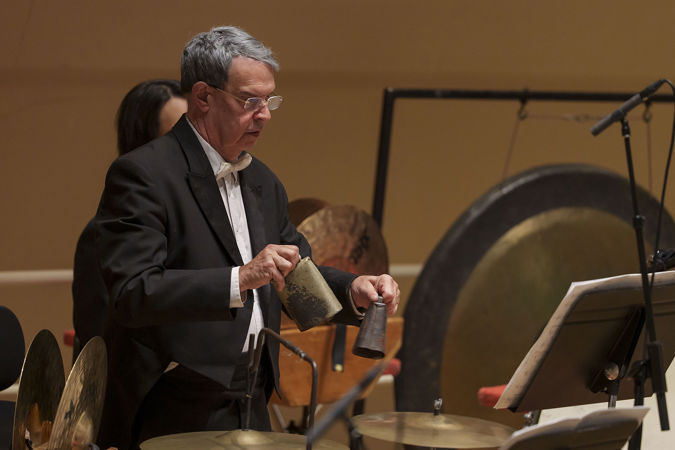 Closeup of former CSO percussion Jim Ross playing the cowbells