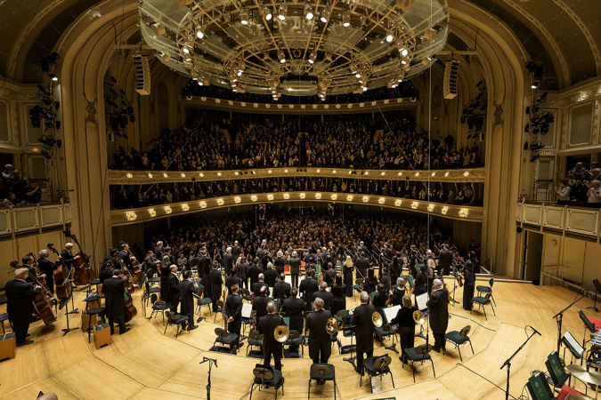 point of view from behind the Orchestra, as they look out on a packed house and take a collective bow with Riccardo Muti