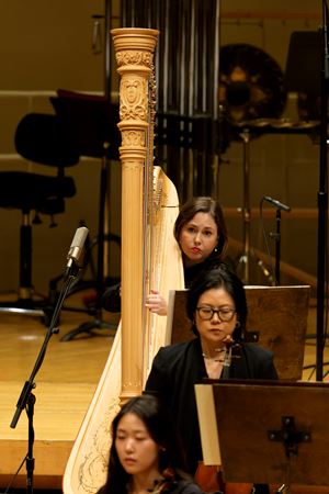 Action shot of CSO harp player Julia Coronelli