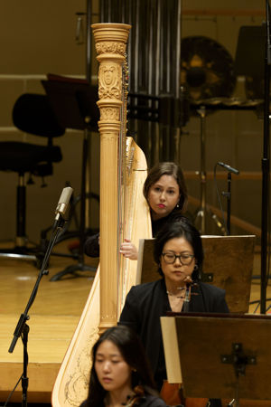 Action shot of CSO harp player Julia Coronelli