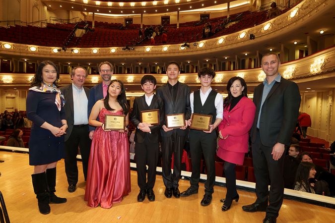 A group shot of all four 2025 Young Artists Competition finalists with the four guest judges and Q&A interviewer Robbie Ellis