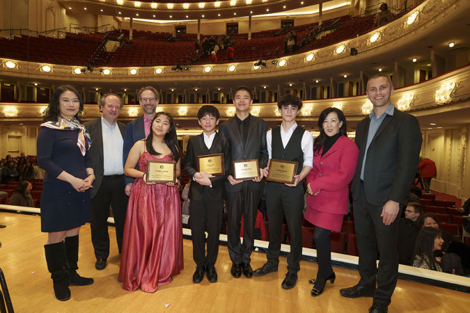 A group shot of all four 2025 Young Artists Competition finalists with the four guest judges and Q&A interviewer Robbie Ellis