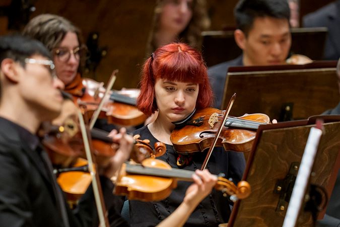 Group Shot Of Civic Violinists On Stage
