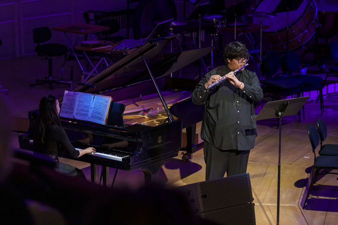 A photo of Chicago Musical Pathways Initiative Fellow Jacob Cornejo playing the flute with pianist Mio Nakamura