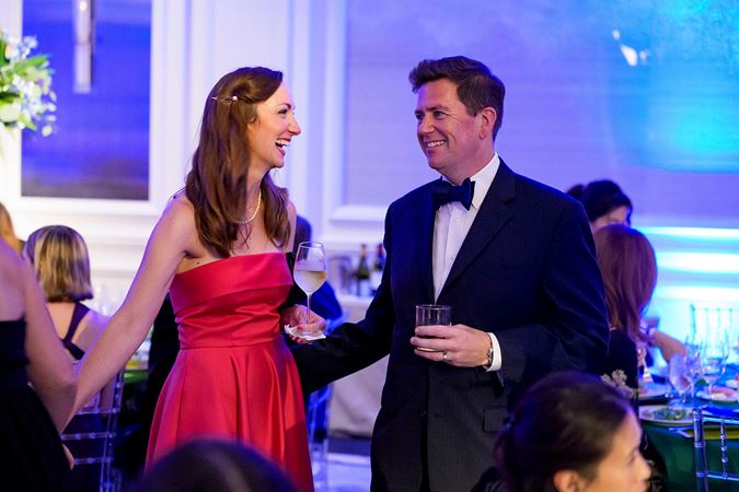 Closeup shot of CSO principal trombone Tim Higgins and wife standing and smiling at each other