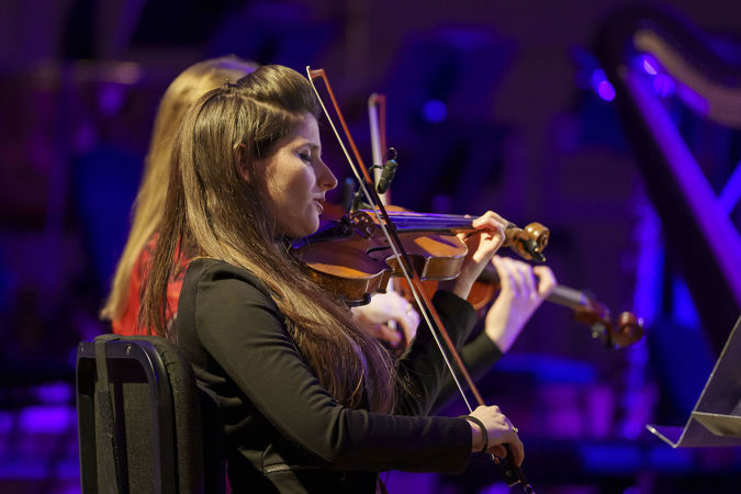 Close up of ATLYS violinist Sabrina Tabby performing on stage