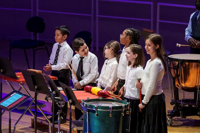 Percussion Scholarship Program students on smiling on stage