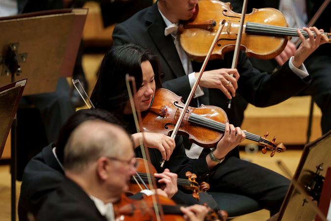 Closeup action shot of CSO violin Ni Mei