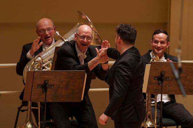 it's all smiles as James Gaffigan shakes the hand of CSO acting principal trombone Michael Mulcahy after the performance