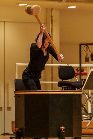 Closeup action shot of CSO principal percussion Cynthia Yeh raising the Mahler hammer on the drum in Mahler 6