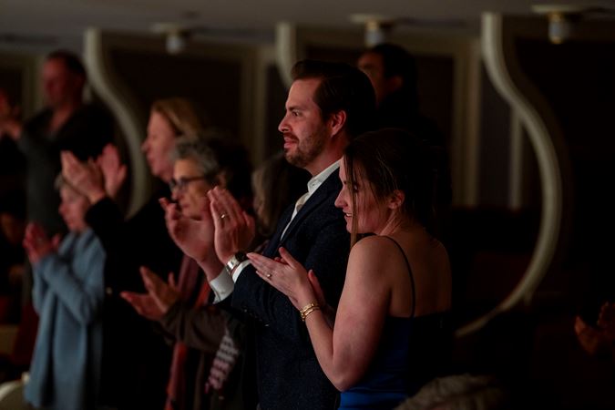 audience members applaud