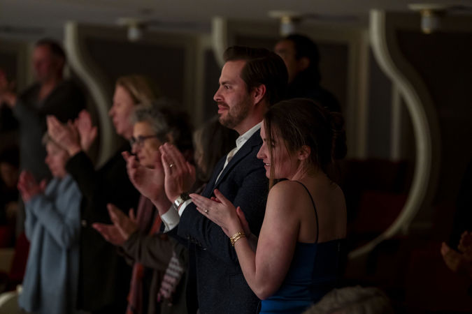 audience members applaud