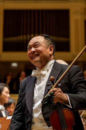 Robert Chen smiles during a solo bow