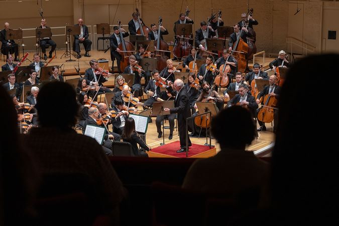 view of the conductor and Orchestra from the box level