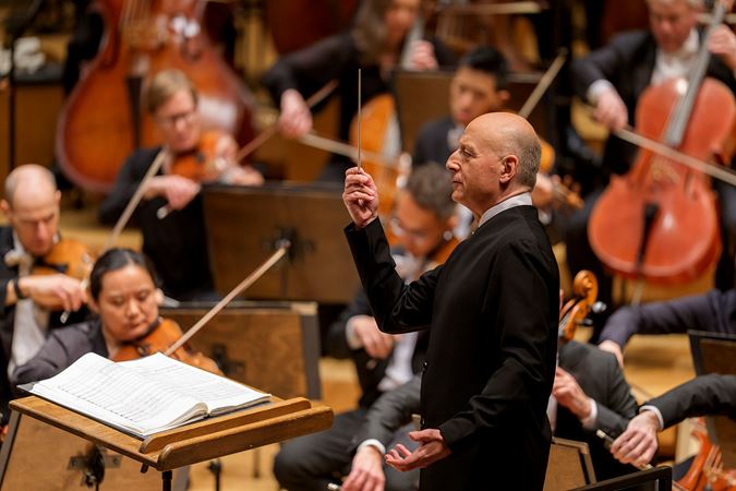 conductor Paavo Järvi holds his baton straight up in the air, ready for an impending downbeat in Sibelius' Second Symphony