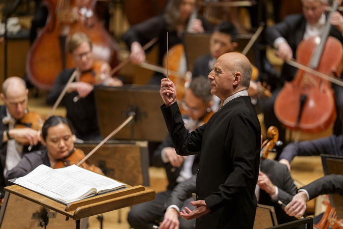 conductor Paavo Järvi holds his baton straight up in the air, ready for an impending downbeat in Sibelius' Second Symphony