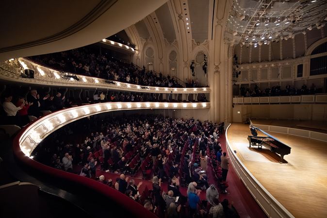 a point of view from the box level as the entire audience gives Behzod a standing ovation