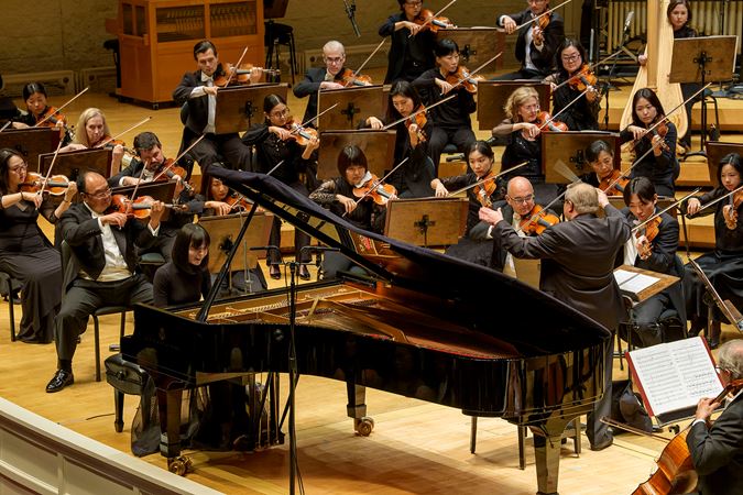 Action shot of pianist Alice Sara Ott, conductor Mikko Franck and the Chicago Symphony Orchestra