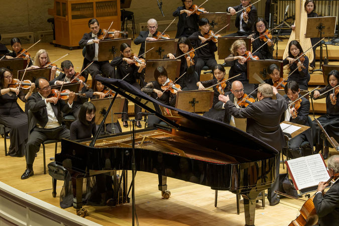 Action shot of pianist Alice Sara Ott, conductor Mikko Franck and the Chicago Symphony Orchestra
