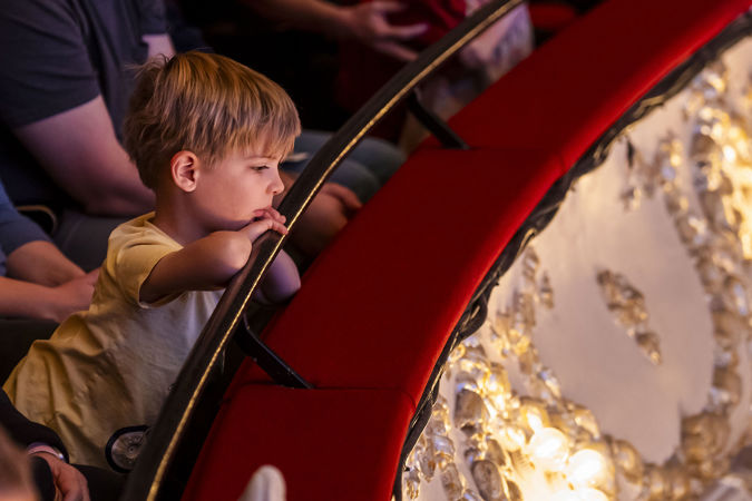 little boy watching over railing