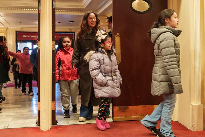 Students and a guardian entering Orchestra Hall on the main floor