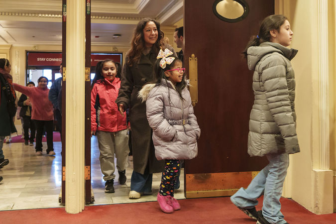 Students and a guardian entering Orchestra Hall on the main floor