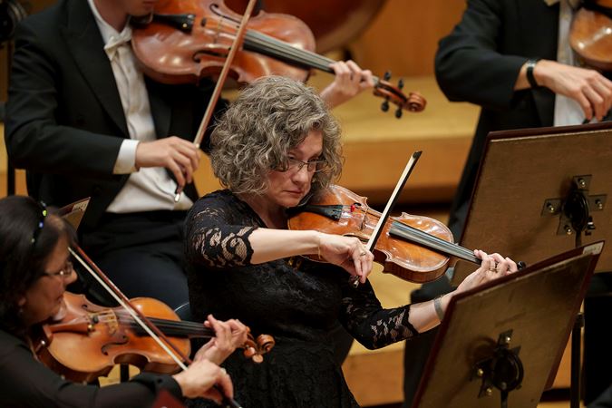 Closeup action shot of a CSO violin player