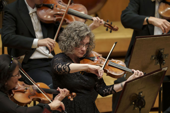 Closeup action shot of a CSO violin player