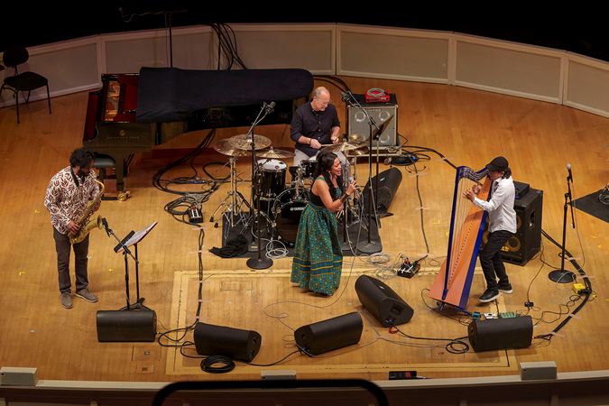 harpist Edmar Castañeda and his quartet, including saxophone, drums and vocals, perform a song together