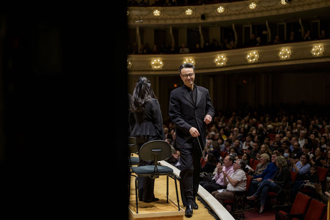 Closeup action shot of principal conductor Ken-David Masur walking off stage after concluding the Civic's first appearance of the season at Symphony Center