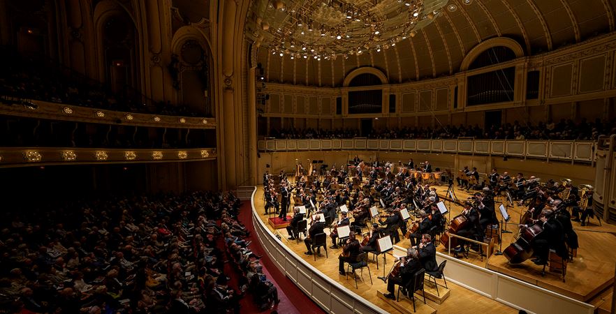 a panorama of the audience and orchestra during the performance
