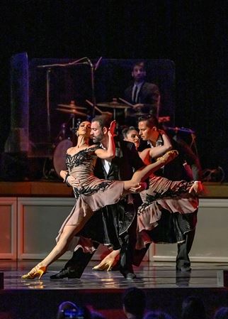 two couples engage in a dip during a tango performance