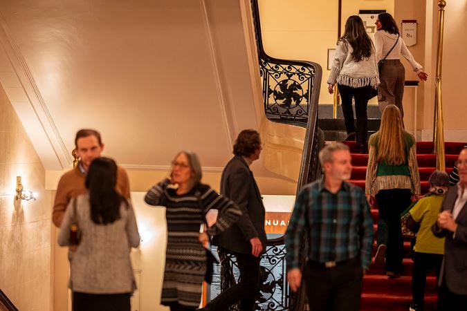 concertgoers file up the staircase to take their seats before showtime