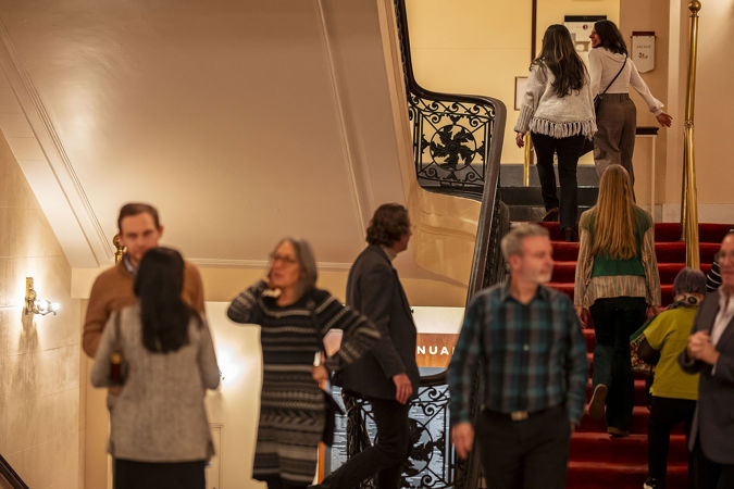 concertgoers file up the staircase to take their seats before showtime