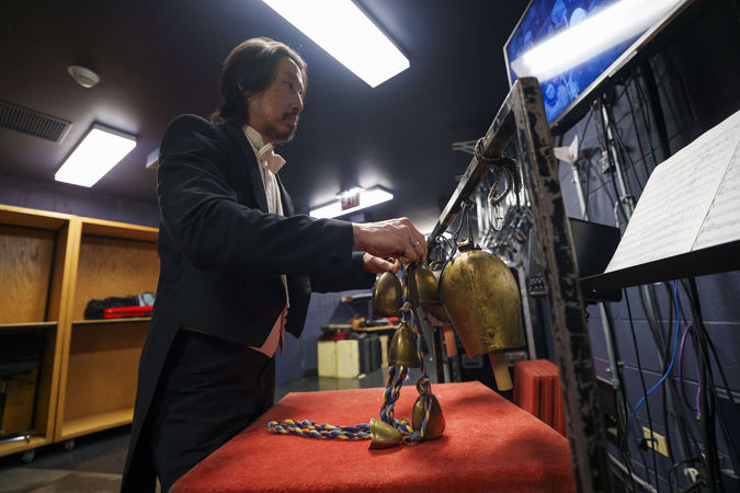 guest percussionist Ian Ding performs an off-stage passage on the cowbells