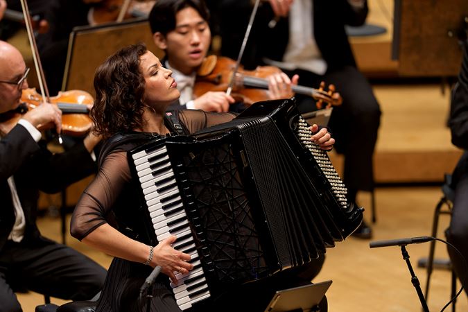 accordion soloist Ksenija Sidorova closes her eyes as she feels the music during her performance of Tüür's concerto