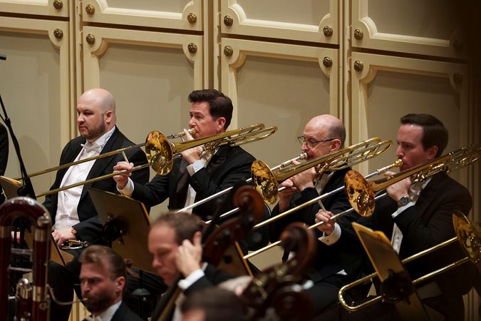Action shot of the CSO trombone section
