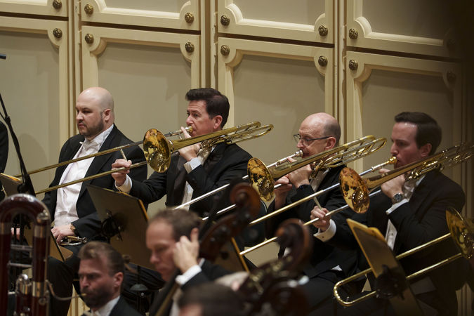Action shot of the CSO trombone section