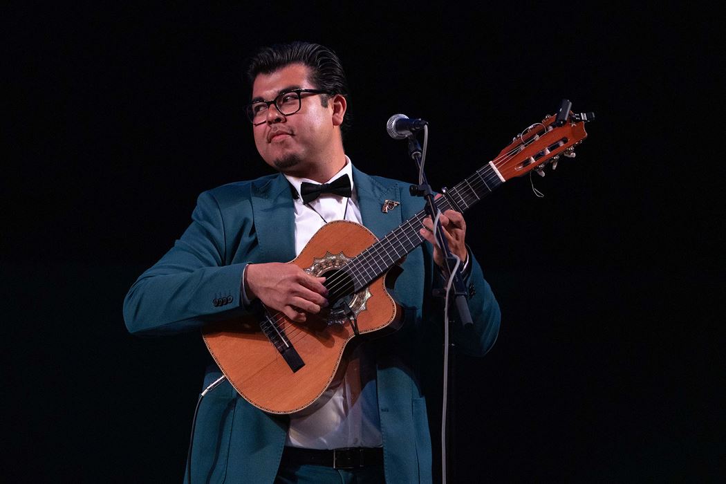 Jesus Martinez of the trio Tres Souls plays the guitar while looking for a cue from his fellow bandmates