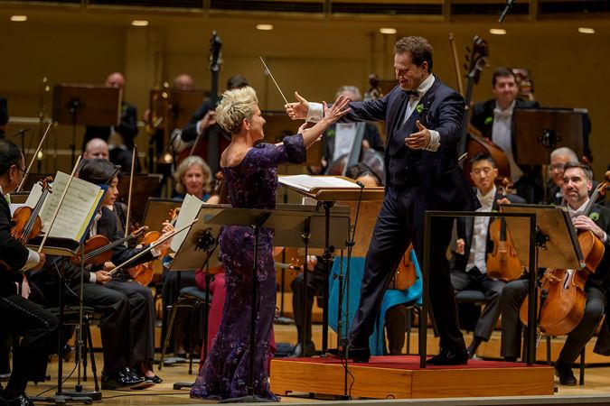 CSO Artist-in-Residence and mezzo-soprano Joyce DiDonato and conductor Nikolaj Szeps-Znaider walking towards each other for a hug on stage