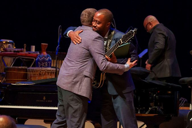 Benny Green and Dan Wilson embrace on stage after their opening set