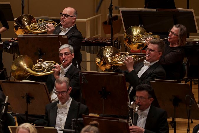 four French horns assume the iconic "bells up" pose during a performance of Rachmaninov's Symphonic Dances