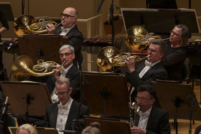 four French horns assume the iconic "bells up" pose during a performance of Rachmaninov's Symphonic Dances