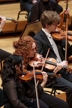 A closeup of two Civic Orchestra of Chicago violinists